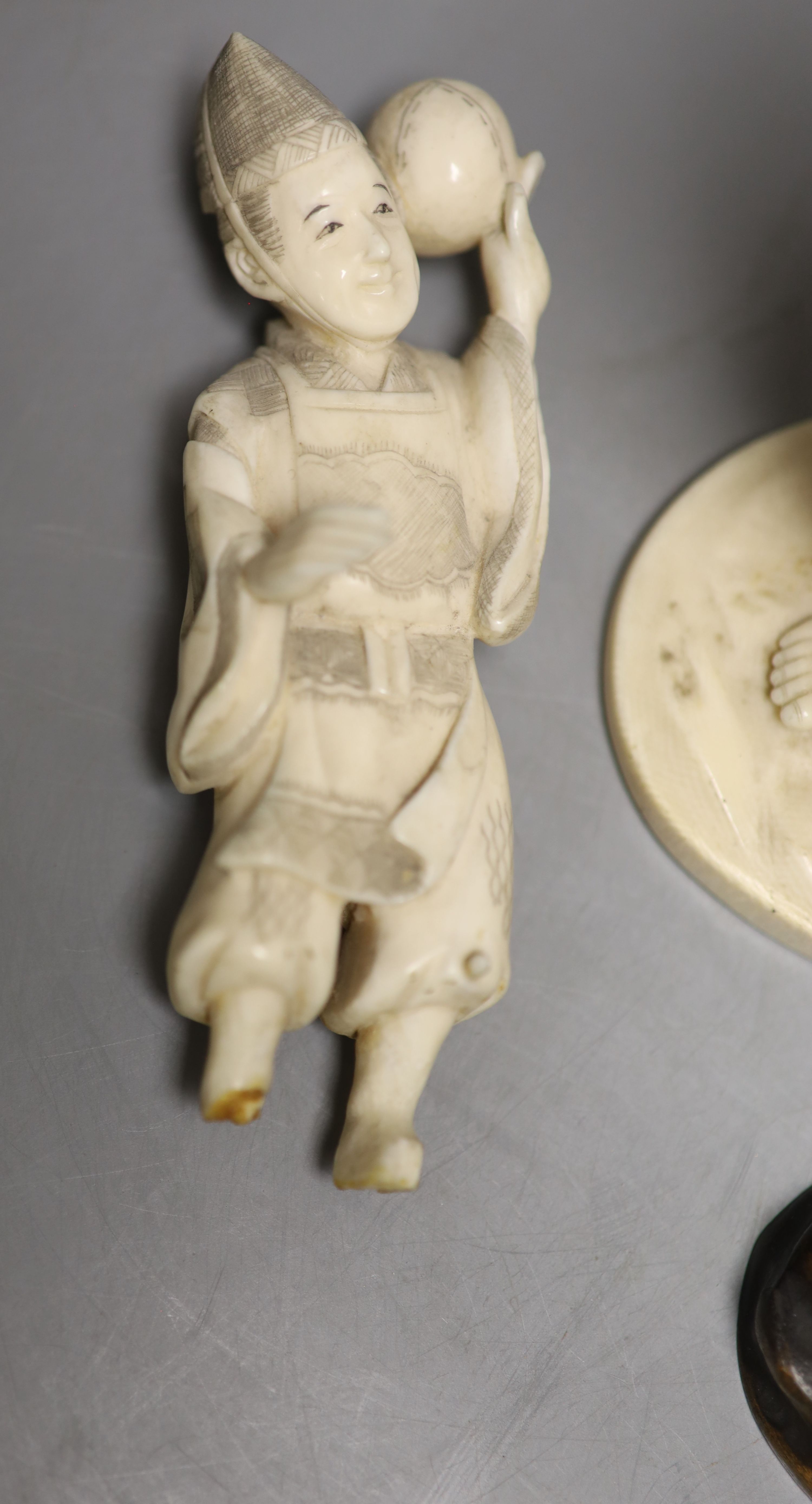 A Japanese Meiji period sectional carved ivory of a man, height 23cm and a Meiji ivory group (damaged)